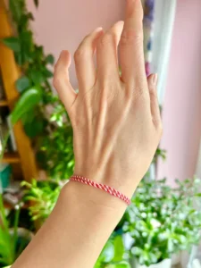 Handmade Romanian Martisor bracelet featuring vibrant red and white colors